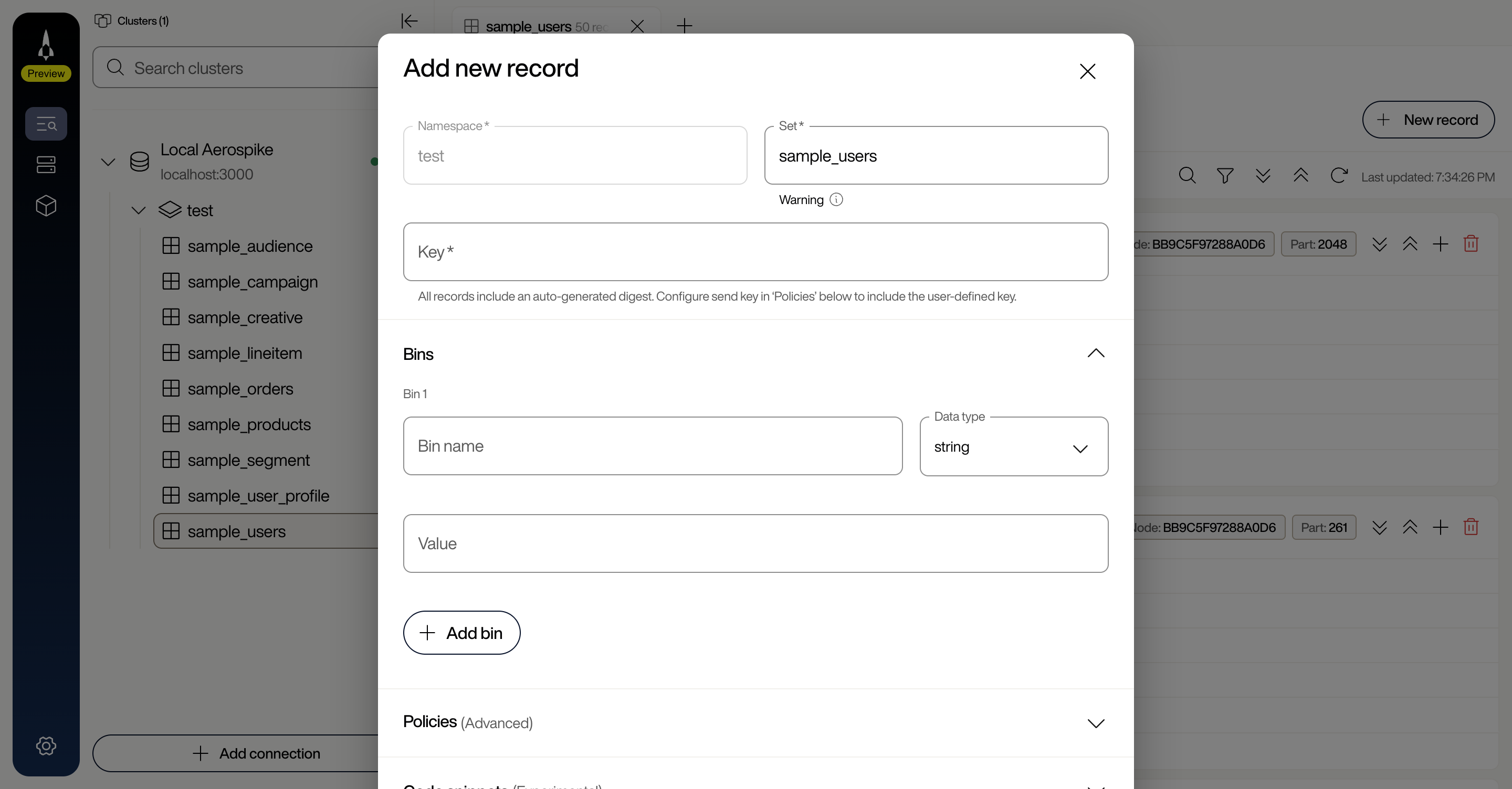 Add new record dialog showing Namespace (pre-filled as test), Set (pre-filled as sample_users), Key field, Bins section with Bin name and Data type dropdown, and collapsed Policies (Advanced) section